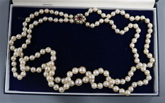 A double string graduated cultured pearl necklace with 9ct gold, pearl and gem set clasp, 52cm.